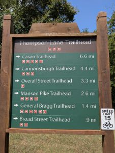 Thompson Lane Trailhead sign listing distances to other Murfreesboro Greenway trailheads.